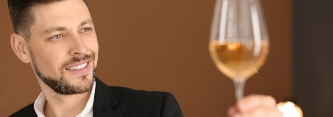 Abbildung ein Mann betrachtet ein Glas voll Wein